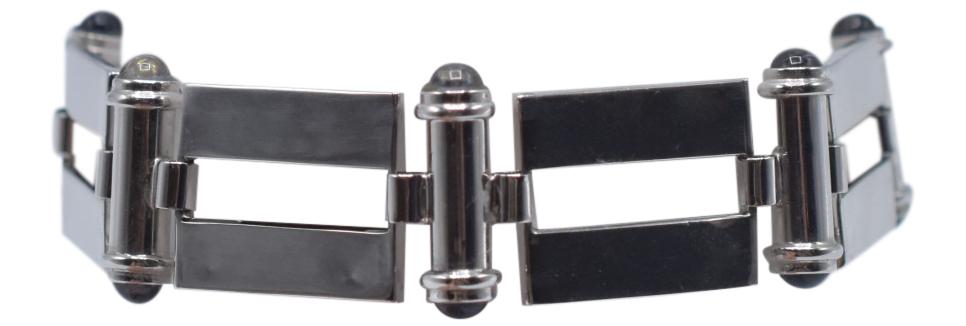 18K White Gold & Iolite Bracelet: Metal Type: 18K White Gold Gemstone: Iolite Round Cabochons Setting: Bezel Gemstone Count: 14 Carat Weight: 3.29 Hallmark: 18K ; ITALY Condition: Very Good Dimensions: 3 1/4 in. diameter x 11/16 in. h