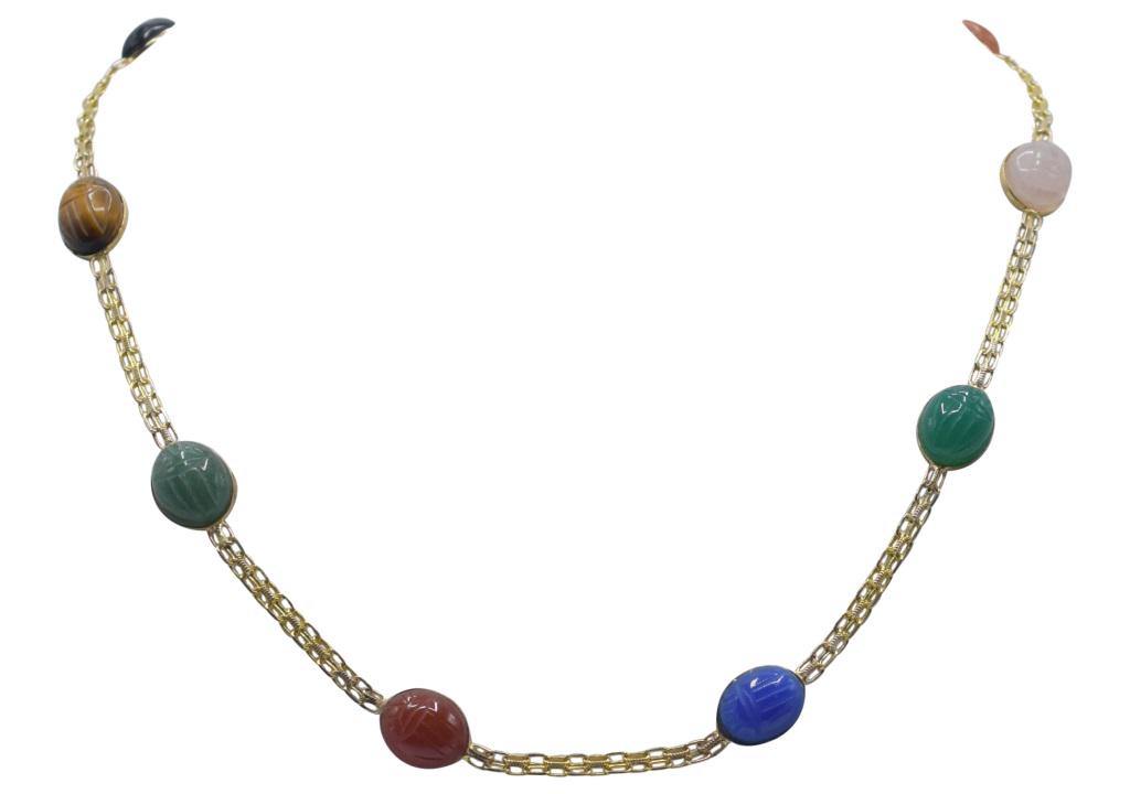 14K Yellow Gold Scarab Necklace: Metal Type: 14K Yellow Gold Gemstone: Carved Black Onyx Scarab Gemstone Count: 1 Gemstone: Carved Tigers Eye Scarab Gemstone Count: 1 Gemstone: Carved Green Jadeite Scarab Gemstone Count: 1 Gemstone: 
