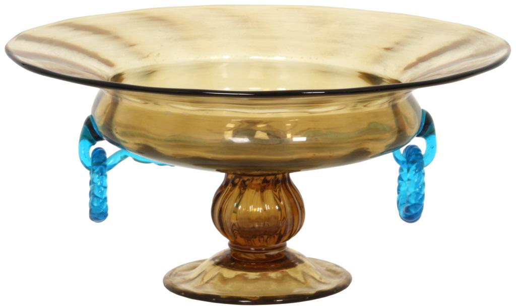 Steuben Two-Color Glass Compote: Steuben two-color compote has an amber glass low form body with a flaring rim and applied blue glass ring handles; the bowl is supported by a round foot with a knobbed, ribbed stem. Signed on the unde