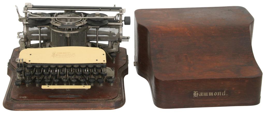 Hammond Typewriter with Case: Hammond Typewriter Company Typewriter with case cast iron, oak signed with metal tag early 20th century 7 1/2 in. high x 14 in. wide x 14 in. deep