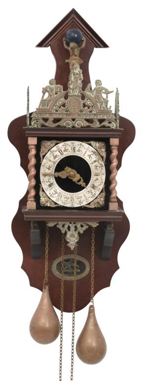 Walnut Wall Regulator Clock: Wall regulator clock with walnut case, figural crest, Roman hour numerals and two pear-shaped weights, 20th century. 25 in. high x 9 in. wide x 6 1/2 in. deep