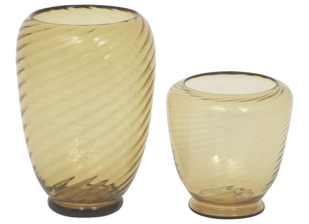 Two Steuben Glass Vases: Steuben Glass Works Two amber vases with ribbed bodies colored glass unsigned early 20th century 6 3/4 in. high x 6 1/2 in. diameter (small) 10 in. high x 7 in. diameter (large)
