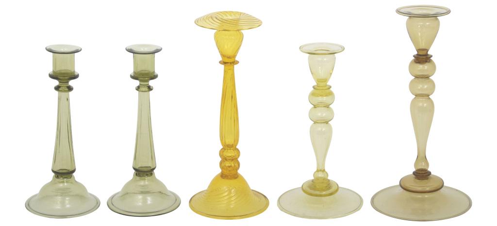 Five Steuben Glass Candlesticks: Steuben Glass Works Group of five candlesticks, including one pair hand blown glass unsigned early 20th century 10 in. high x 4 1/2 in. diameter (small) 12 in. high x 5 3/4 in. diameter (large)