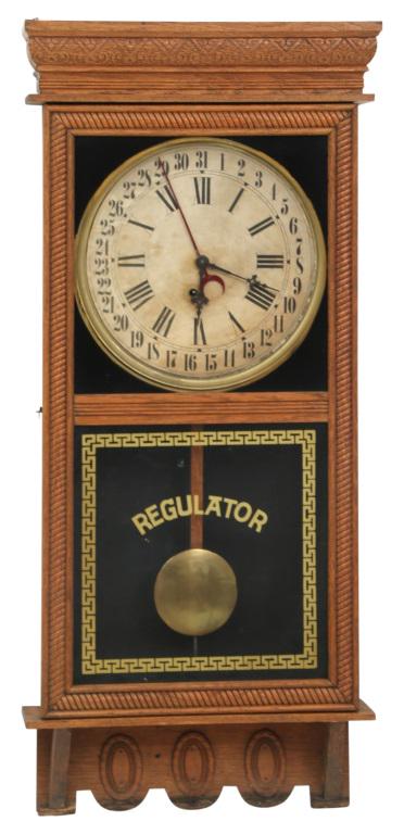 Ingraham "Northwestern" Hanging Calendar Clock: E. Ingraham Co. "Northwestern" wall hanging calendar clock with eight-day, time and calendar movement, 12-inch dial oak case, reverse-painted glass movement signed "E. Ingraham Co., Bristol, CT, U.S.A