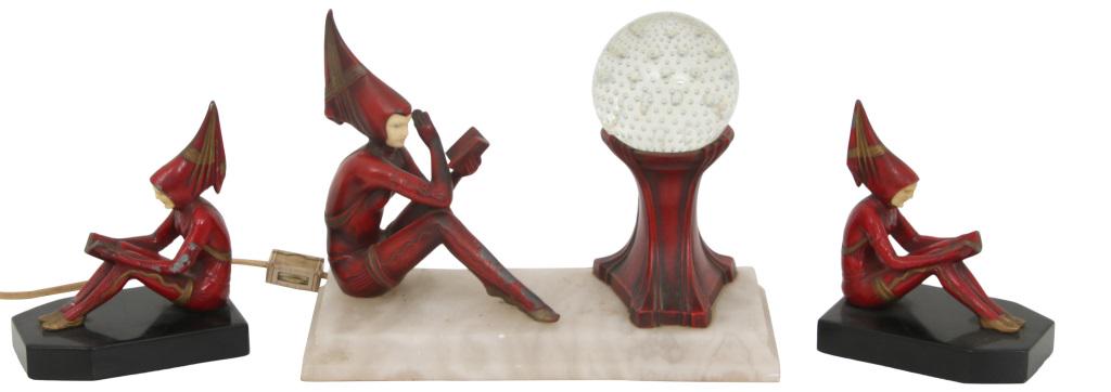 Art Deco Pixie Readers & Crystal Ball Lamp: Reading pixie figure sitting next to a controlled bubble paperweight style lamp on a white alabaster base, accompanied by two reading pixie figures on black bases. The lamp is in working condition, pi