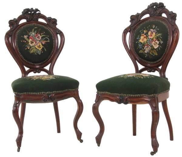 Pair of Pierced Carved Walnut Side Chairs: Pair of pierced carved walnut side chairs have flowing rococo filigree with flowers on the crest, stands on cabriole legs, mid-19th century. 41 in. high x 19 in. wide x 18 in. deep