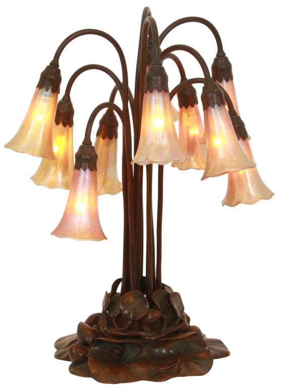 Tiffany Studios 10 Light Lily Lamp: Tiffany Studios lily lamp has a bronze pond lily pad base with floral buds and 10 long tubular stems curling over at the top with porcelain sockets and leafy fitters at the ends; signed on the undersi