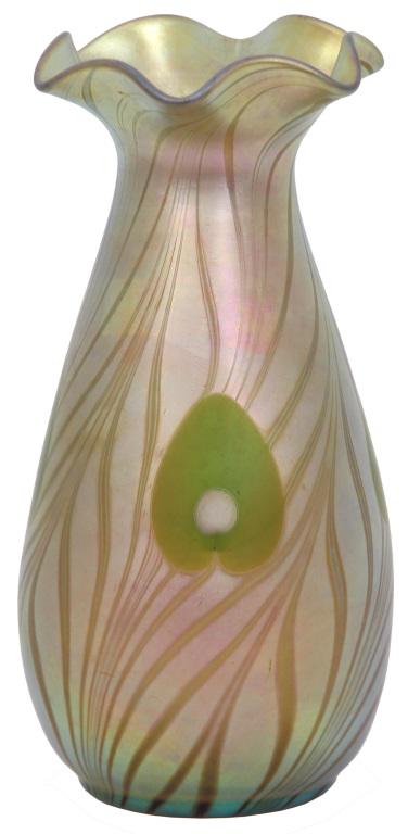 Steuben Peacock Feather Vase: Steuben gold Aurene peacock feather vase has a blue iridescent pulled feather design throughout with four green peacock feather eyes; set against a gold iridescent background. The vase is in a baluste