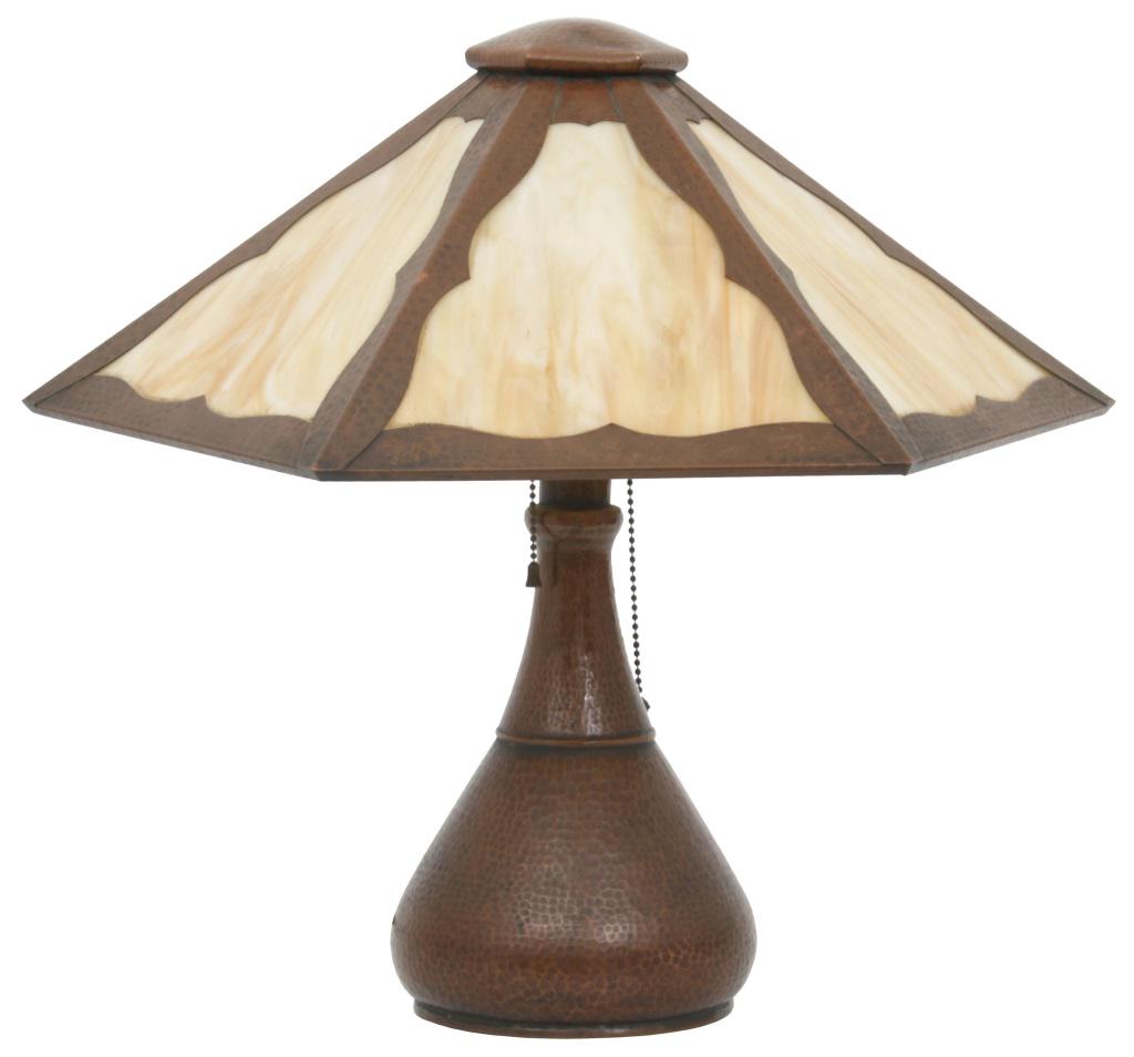 Stickley Brothers Copper Lamp: Stickley Brothers hammered copper lamp has a hexagonal shade with caramel slag glass panels, supported by a bulbous base having a two-socket light cluster. Good condition with some patina wear, a repl