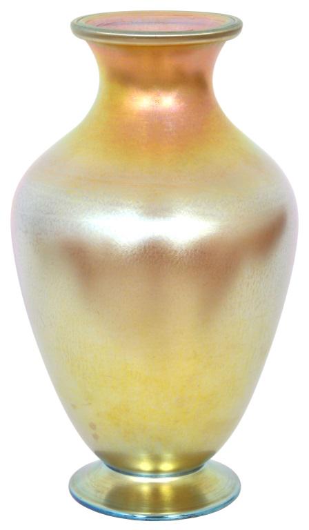 Tiffany Studios Favrile Glass Vase: Tiffany Studios Favrile glass vase has deep gold iridescence, baluster form and is raised on a circular foot. Signed on the underside, "Louis C. Tiffany Favrile 9395 J." Good condition with slight scr