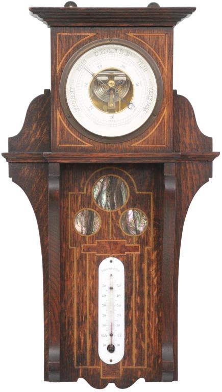 Arts & Crafts Inlaid Barometer: Arts and Crafts barometer with a 4 1/2 in. diameter dial, thermometer and an oak case with string inlay and three round mother of pearl medallions. 19 in. high x 10.5 in. wide x 3.5 in. deep.