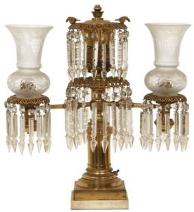 Brass Two-Arm Argand Lamp: Brass two-arm Argand lamp has two perched birds over cut glass prisms, two arms branching out to the sides and then forward that hold berry cluster cut glass shades and prisms. 24 in. high x 22 in.