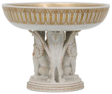 KPM Porcelain Compote: KPM porcelain compote has a gilt decorated bowl with interior and exterior borders and a center medallion of an Egyptian woman's head. The bowl is supported by three Egyptian winged griffins having