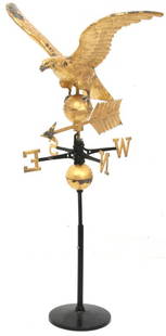 19th Century Gilt Eagle Weathervane: 19th century gilt eagle weathervane with spread wings and perched on a ball centered on an arrow, four directionals are intact above a second ball. 59 in. high x 30 in. wide x 29 in. deep.