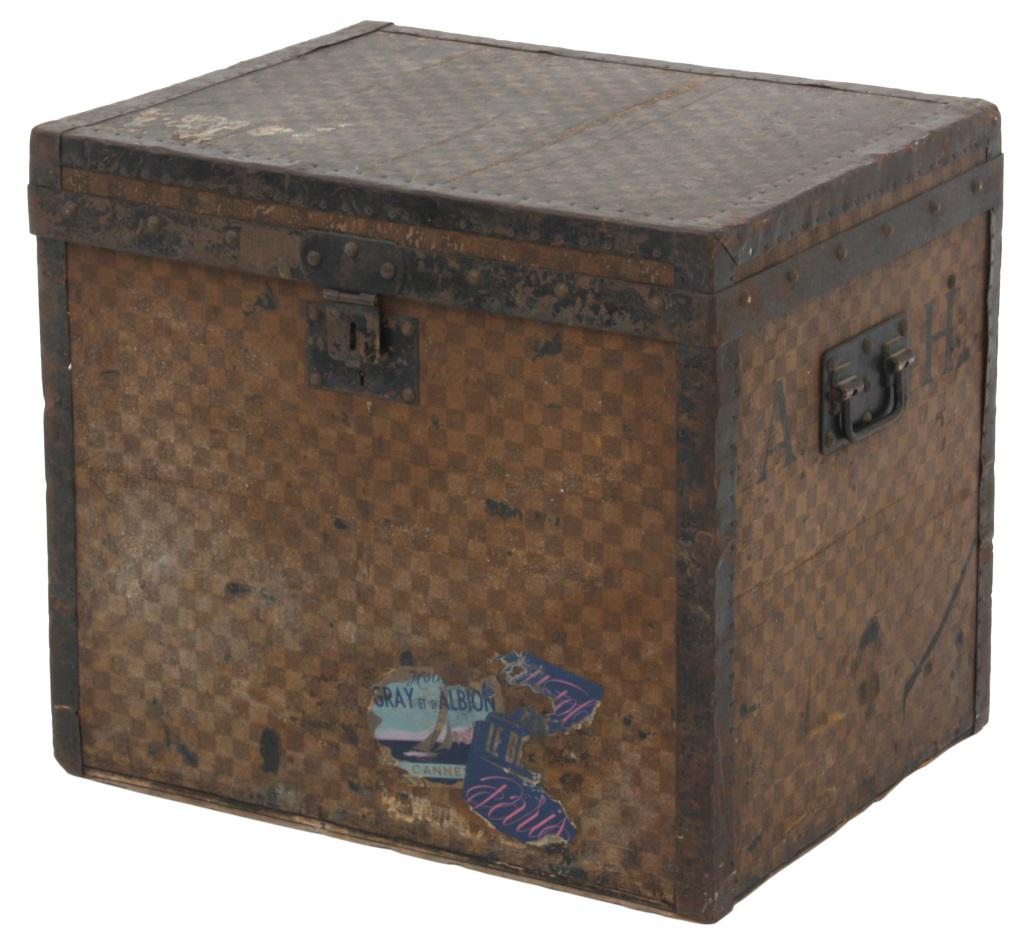 Louis Vuitton Damier Cube Trunk: Fairly rare size, the trunk has a checkerboard pattern Damier canvas covered exterior with iron corner straps and brass tacks, iron side handles and lock; original paper over canvas lined interior, 2 