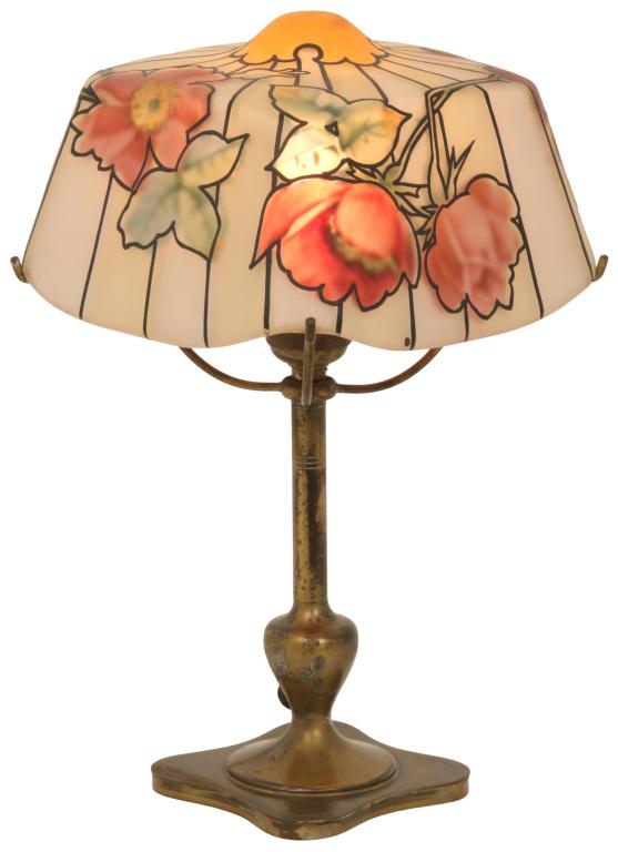 Pairpoint Portsmouth Boudoir Lamp: Pairpoint boudoir lamp has a Portsmouth shade featuring reverse painted roses with black enamel outline on the exterior, supported by a gilt metal base signed "Pairpoint Mfg. Co." and numbered "E3023.
