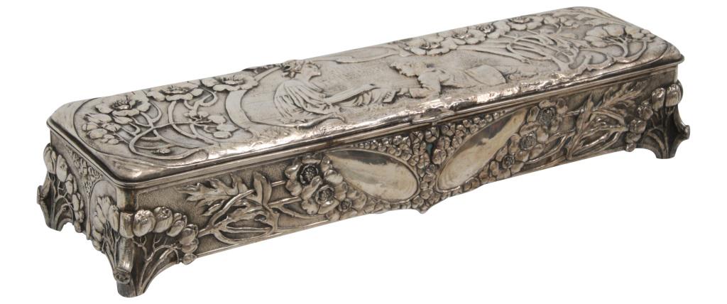 Art Nouveau Jewelry Casket: Art Nouveau silver plated jewelry casket is decorated with flowers and vines surrounding a scene of a man playing a musical instrument besides a woman. Good condition with minor dents on high points. 