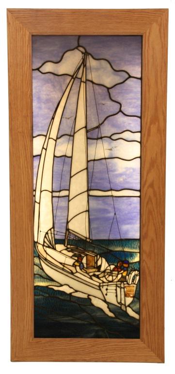 Scenic Leaded Glass Sailboat Window.: Tall leaded glass window depicts a white sail boat on the seas under cloudy blue skies, 2 figures are seated in the boat and the captain navigates; an obverse painted panel at the stern reads â€œB