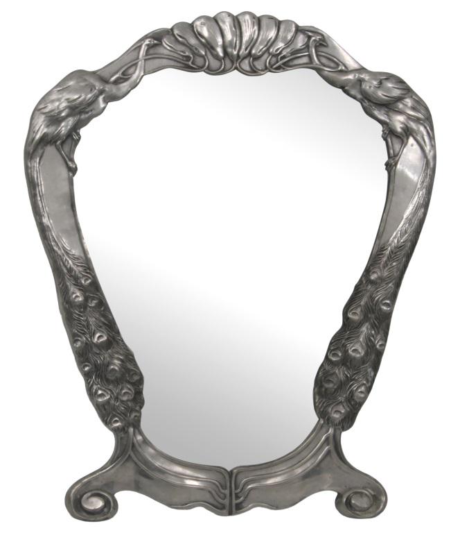 Silver Plated Peacock Mirror: Silver Plated mirror decorated with two flanking peacocks, marked "ISIS 521." 12 in. high x 13.5 in. wide x 10.5 in. deep.