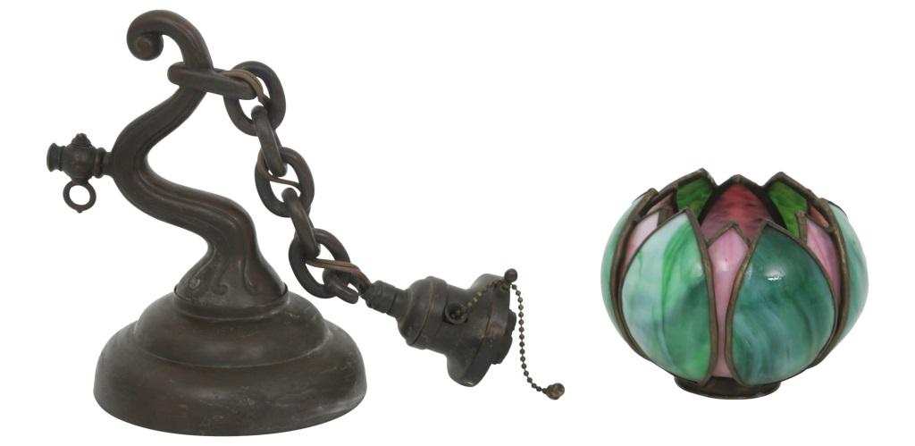 Handel Wall Sconce: Handel patinated metal wall sconce has a curving arm supporting the chain that holds the green and pink glass tulip shade; signed "Handel" on the back of sconce. 16 in. high x 6 in. wide x 9 in. deep.