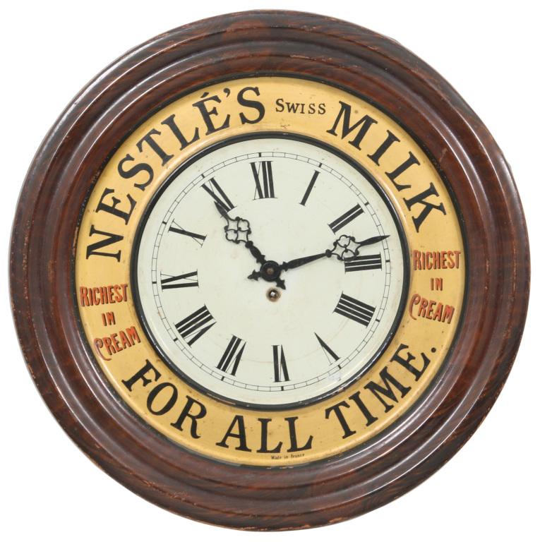 Nestle's "Swiss Milk" Advertising Wall Clock: Nestle's "Swiss Milk, For All Time" advertising wall clock with a tin front case that's grain-painted along the outer diameter, French manufacture 8 day time only movement, wear to paint along the edg