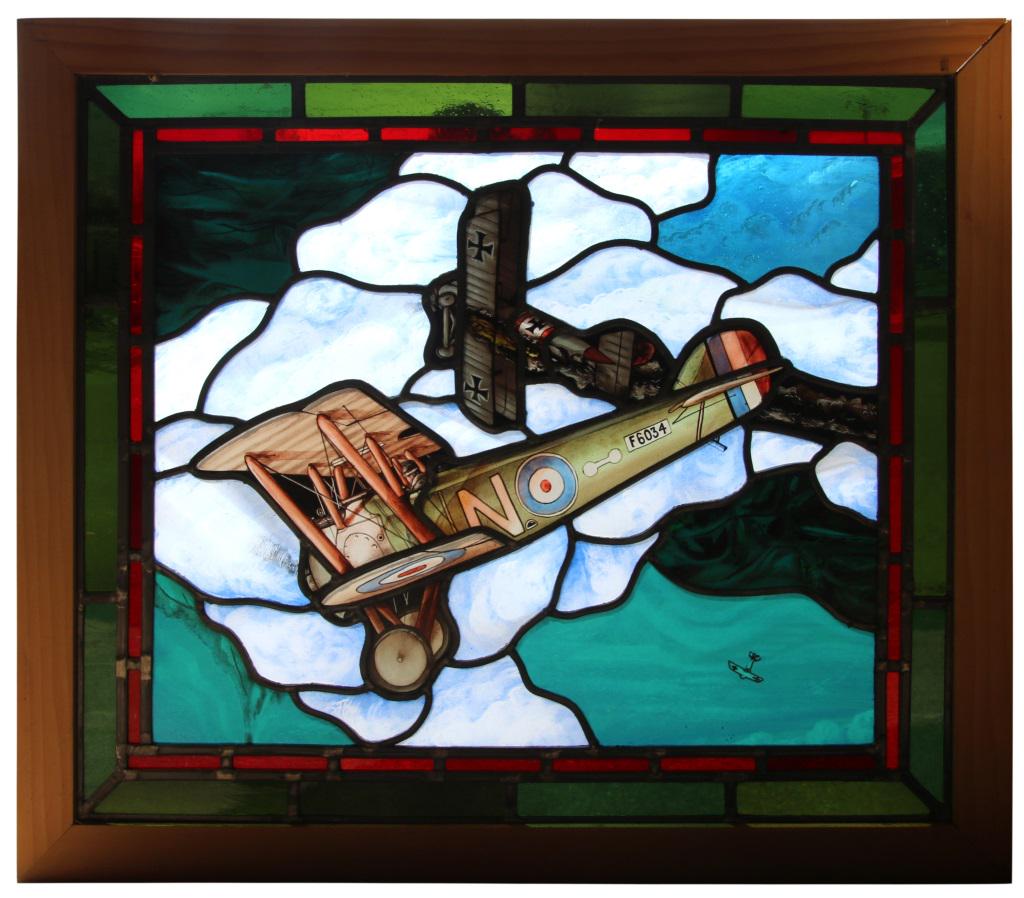 Leaded & Stained Glass Airplane Window: Leaded and stained glass window depicting three biplanes, two up close and one far in the distance. 20 in. high x 23 1/2 in. wide.