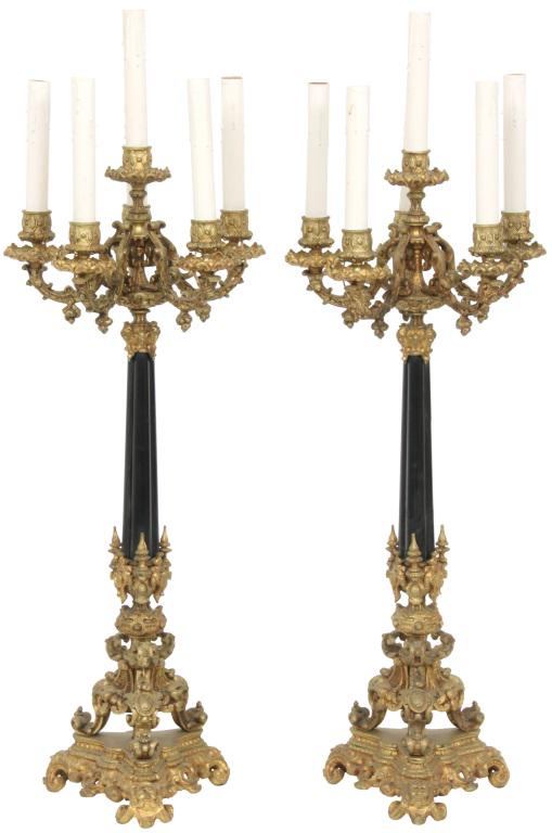 Pair of Gilt Bronze Six Arm Candelabra: Pair of gilt bronze candelabra with finely detailed scrollwork and filigree decoration, five candle arms surrounding a central candle holder and a three-legged base with mythical faces. 33 in. high x 