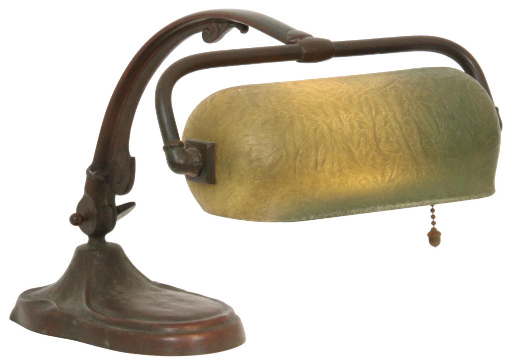 Handel Mosserine Desk Lamp: Handel desk lamp has a chipped ice and obverse-painted green mosserine shade, supported by a patinated metal base having a long, arched adjustable arm. The shade is signed "Mosserine Handel 6010" on t