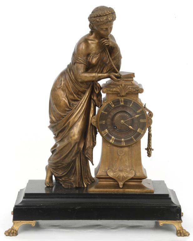 French Bronze Figural Mantel Clock: French Bronze Figural Mantel Clock, gilt metal woman gazing at a pendant while leaning on an Art Nouveau clock, mounted to a black marble base supported by paw feet, dial is finished in a darker bronz
