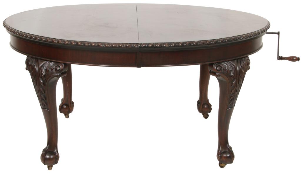 Chippendale Style Dining Table: Chippendale style dining table, oval form with crank for extending the table, gadrooned top edge, acanthus decorated cabriole legs, claw and ball feet, two leaves, 28 1/2 in. high x 58 in. wide x 47 i