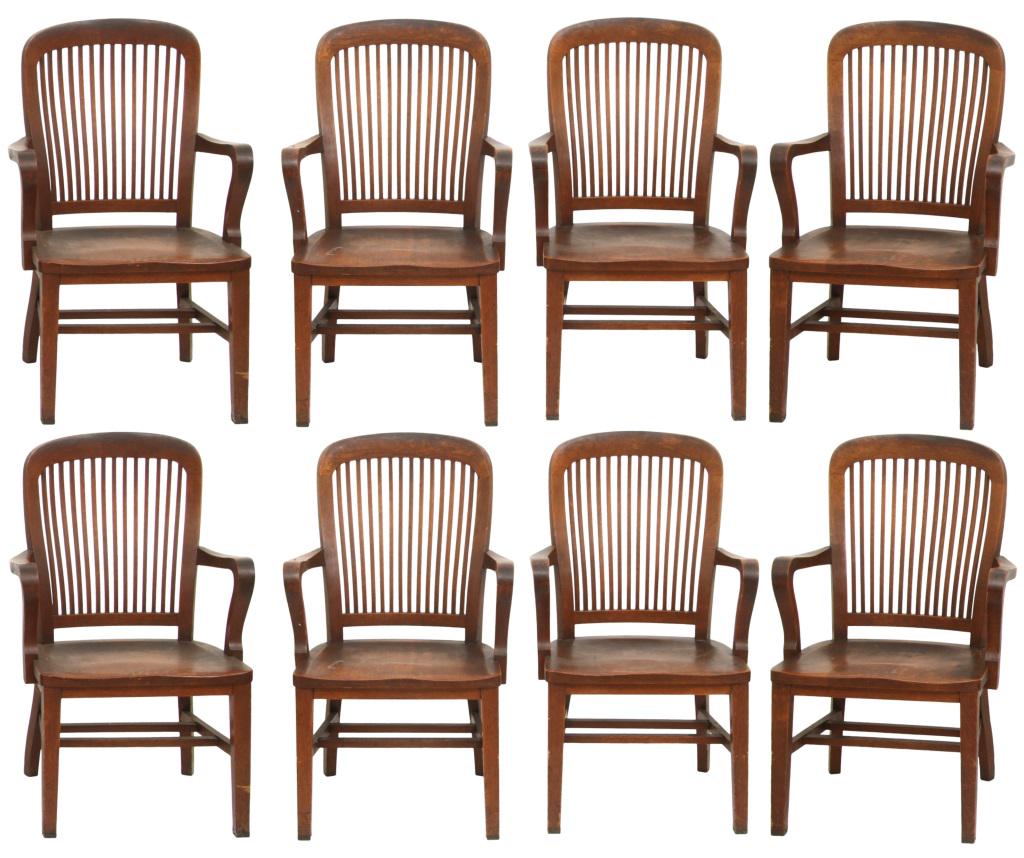 Eight American Oak Armchairs: Eight American oak armchairs, spindle back with saddle plank seat. Perfect use for a conference table or office, retaining their original finish, early 20th century. 43 in. high x 25 in. wide x 20 in.
