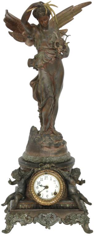 Ansonia "Sibyl and Gloria" Statue Clock: Ansonia "Sibyl and Gloria" statue clock with a winged figure holding a harp and leaves, base with cherubs on either side, original porcelain dial, hands, pendulum and finish, 8-day brass time and gong