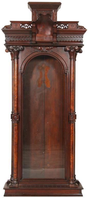Attr. U.S. Clock Co. Regulator Clock Case: Attr. U.S. Clock Co. regulator clock case in walnut with ornamental pediment crest, large turned finials, turned and burled columns on either side of the door. Good overall condition with an enhanced