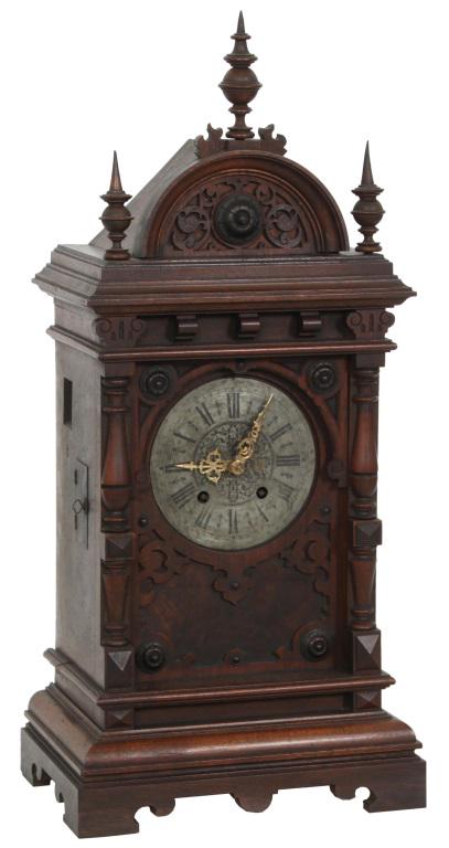 Black Forest Table Model Cuckoo Clock: Black Forest table model cuckoo clock with three spire finials, arched crest enclosing the animated cuckoo mechanism, signed "Karl Klausmann" on the back panel, metal dial with black Roman hour numera