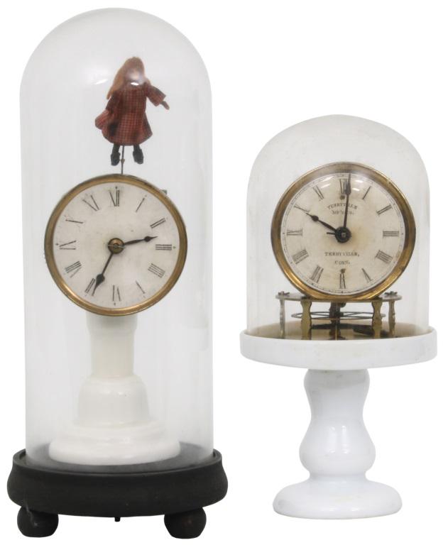 Two Terryville Mfg. Co. Candlestick Clocks: 1) Terryville Mfg. Co. candlestick clock with S.B. Terry patent torsion balance wheel escapement, white milk glass pedestal in good condition with replaced felt, original paper dial, hands and dome, r