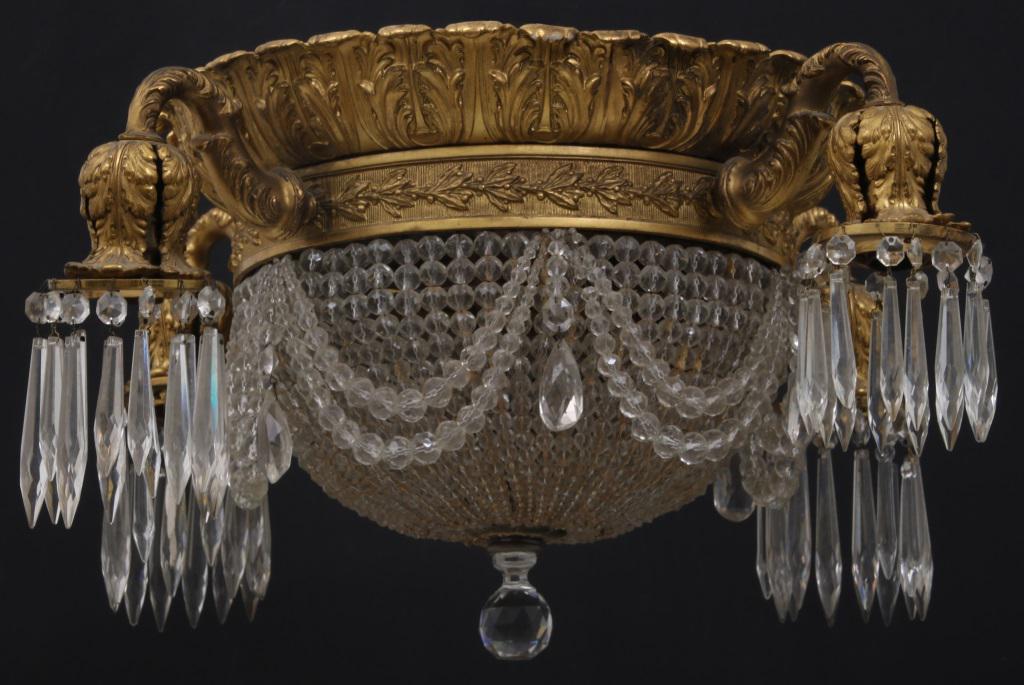 French Gilt Bronze & Beaded Glass Ceiling Fixture: French gilt bronze ceiling fixture with acanthus decorated socket covers and top band, four arms extending from a leaf and berry ornamental band, finished with beaded glass chains and prisms. 12 in. h