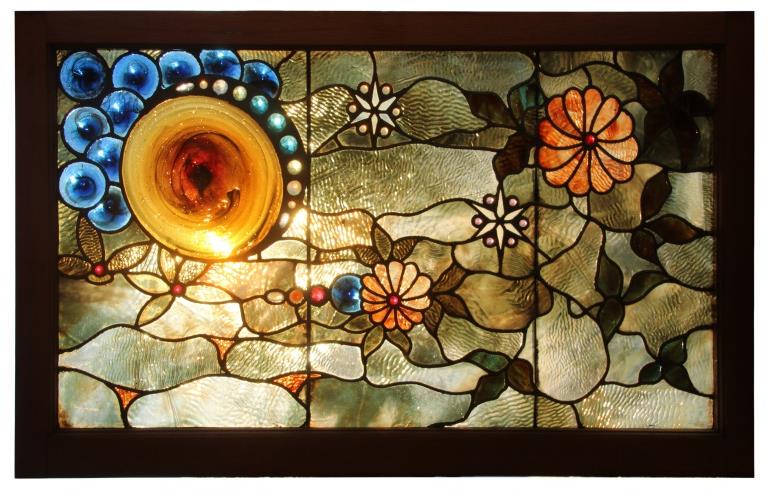 American Leaded & Stained Glass Window: American Leaded & Stained Glass Window early 20th century depicting a sun surrounded with clouds and floral motifs 45 1/2 x 28 1/2 inches