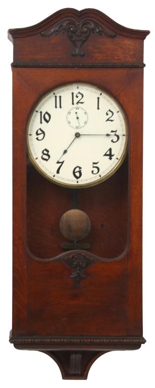 Automatic Electric Clock Company Wall Clock: Automatic Electric Clock Company Wall Clock, Chicago, Illinois, circa 1900, oak case with applied carvings and painted white dial with Arabic numerals, dry cell battery-operated inline movement has tw