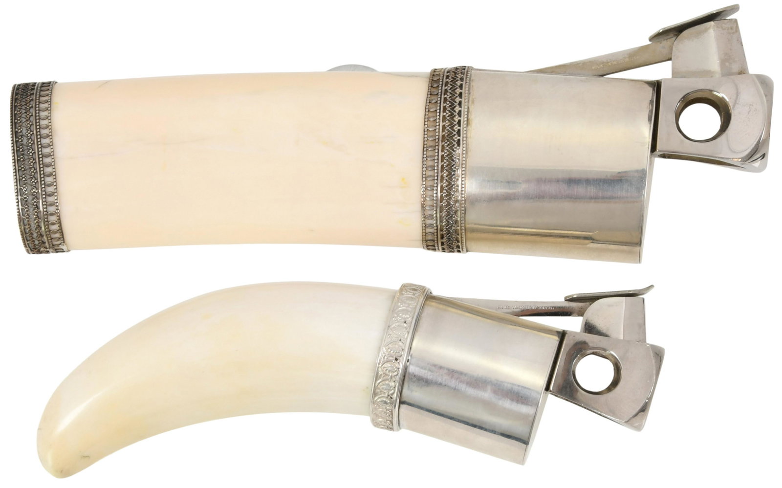 Two German Cigar Cutters: Two German Cigar Cutters 20th century the first carved bone with sterling silver mounts, marked ".925," the second a whale's tooth with silvered metal mounts, both marked "Donatus, Solingen/Made in We