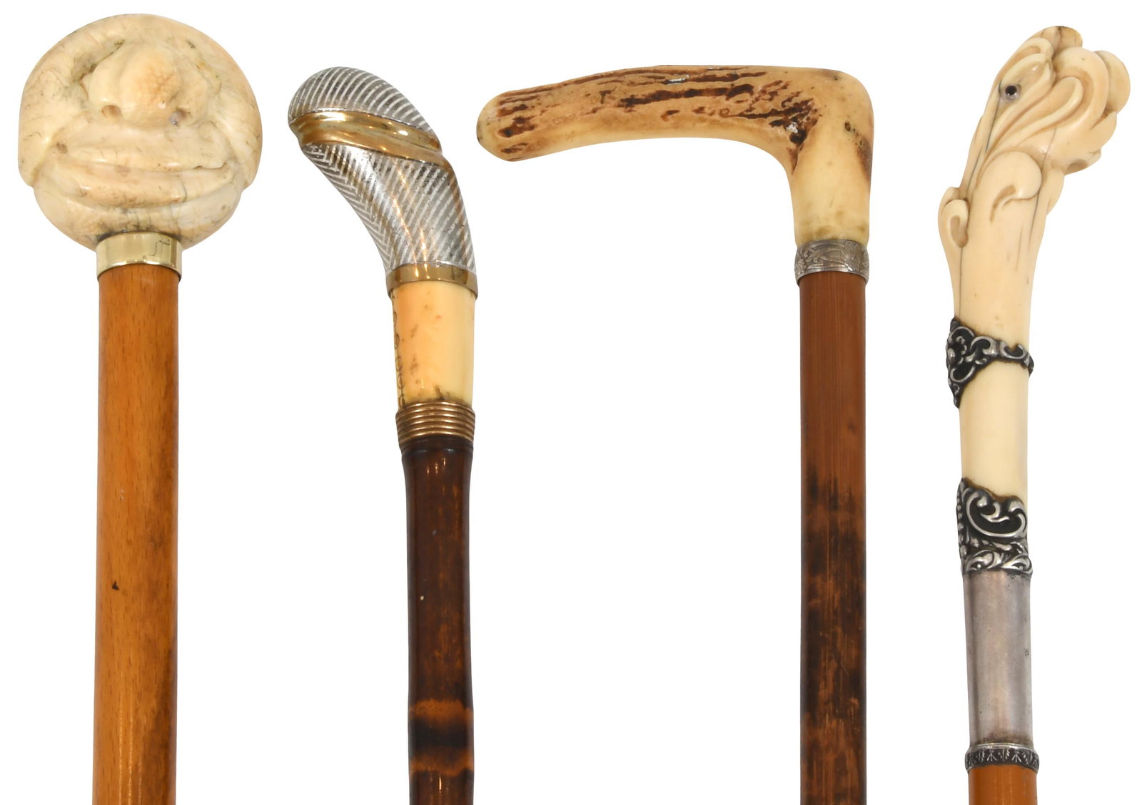 Group of Four Walking Sticks: Group of Four Walking Sticks comprising one with a bone carved face, one with a carved antler, one with chevron silver and one with carved bone and silver 38 1/2 in. long (largest)