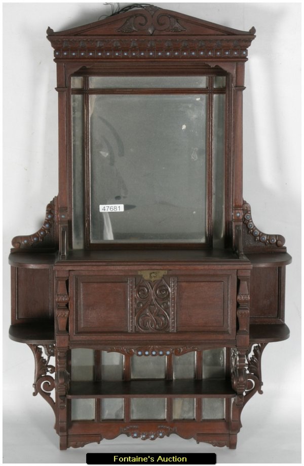WALNUT WALL CABINET: Carved Wall Cabinet With Glass Bead Inserts, Attr. Associated Artists. Beautiful carved walnut cabinet with a scrolled crest, carved side corbels, square columns and a fancy lower gallery; has a mirro