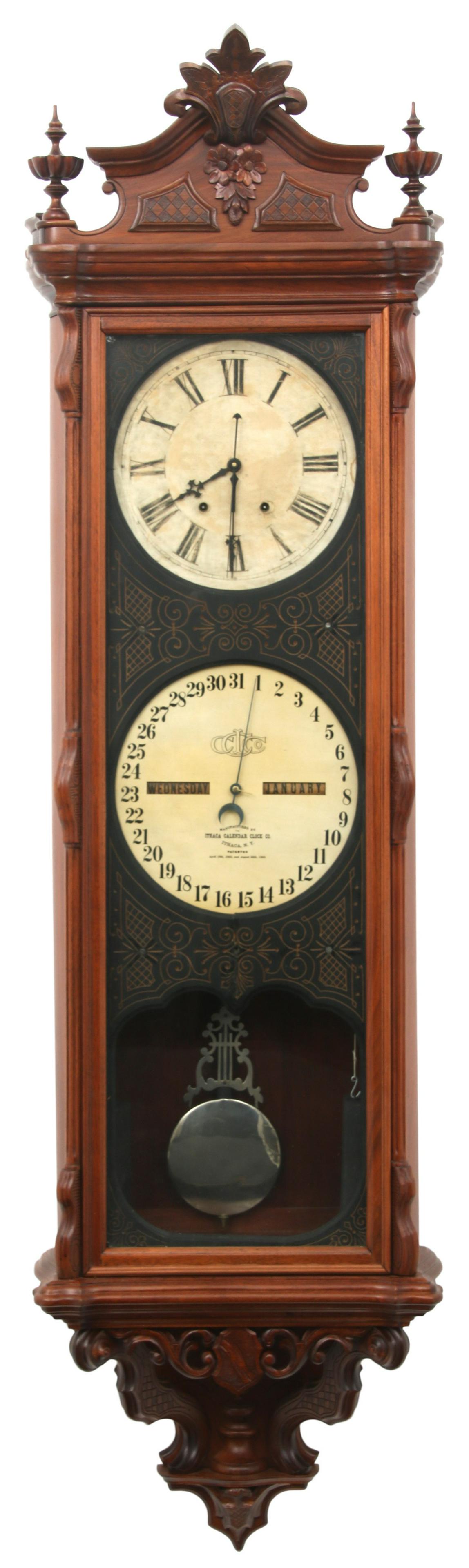 Ithaca Regulator No. 1 Calendar Wall Clock: Ithaca Regulator No. 1 Calendar Wall Clock circa 1870 the walnut case with floral, foliate and scroll carvings, 8-day time only weight driven movement with sweep seconds, lower perpetual calendar mech