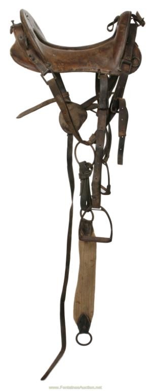 MODEL 1902 McCLELLAN SADDLE: This is a complete saddle with metal stirrups and canvas saddle girth. Leather is in good condition and owners name is scratched into back of saddle.