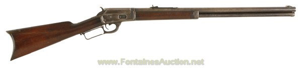 Marlin Model 1889 Lever Action Rifle in 44-40: Round barrel is 24" long and has a fair to good bore with light pitting in the grooves; outside of the barrel is a mix of gray and blue, mostly gray. Magazine tube has about 60% blue. Receiver retains
