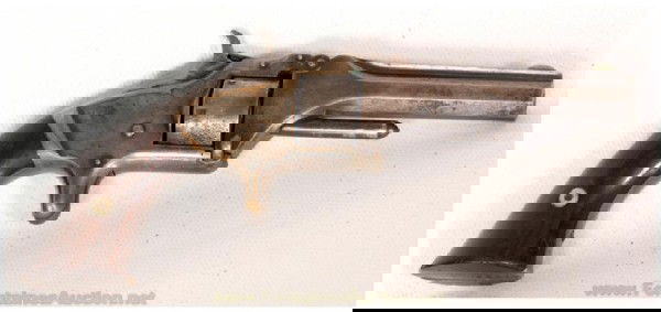 Smith & Wesson Model No. 1 Second Issue Revolver: 3 3/16" Barrel is chambered for 22 short and has a nice bore. SN is 99,450. The barrel is a mix of silver and blue and the frame has hints of brass on the edges. The rosewood grips are in fine conditi