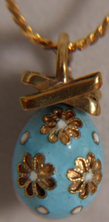 Faberge 14k Gold Russian Enamel Easter Egg Pendant: Faberge Gold Russian Enamel Easter Egg Pendant. 14k Gold w/ light blue enamel and white flowers; bears the "56" gold mark and the Cryillic "K0" letters for the Faberge Workhouse, circa 1887.