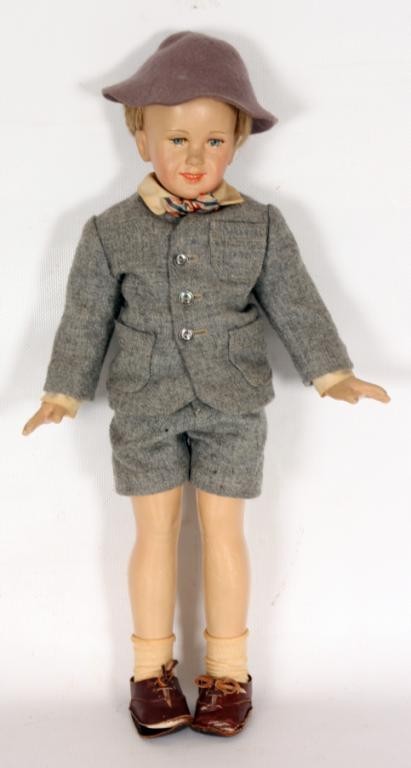Fine French Boy Doll.: Fine French Boy Doll. A hard rubber head, body arms and legs, has leather shoes, a wool jacket w/ matching shorts and a delicately painted face; no markings.