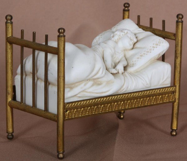 Fine Bisque Child Lying In Bed On Brass Bed Frame.: Fine Bisque Child Lying In Bed On Brass Bed Frame.