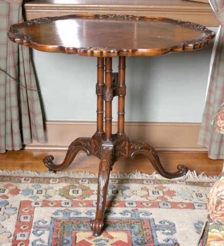 Carved Walnut Candle Stand: A carved piecrust top w/ seashell embellishments on 3 turned columns and cabriole legs. 30"H x 34" Dia.