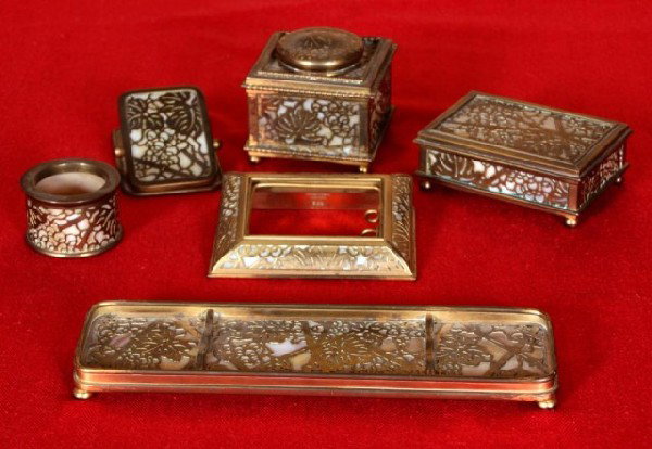 6 Pc Tiffany Studios Grape Vine Desk Set: 6 Pc Tiffany Studios Grape Vine Desk Set. Fine bronze grapevine pattern with a gold finish, laid over caramel slag glass. In excellent condition.